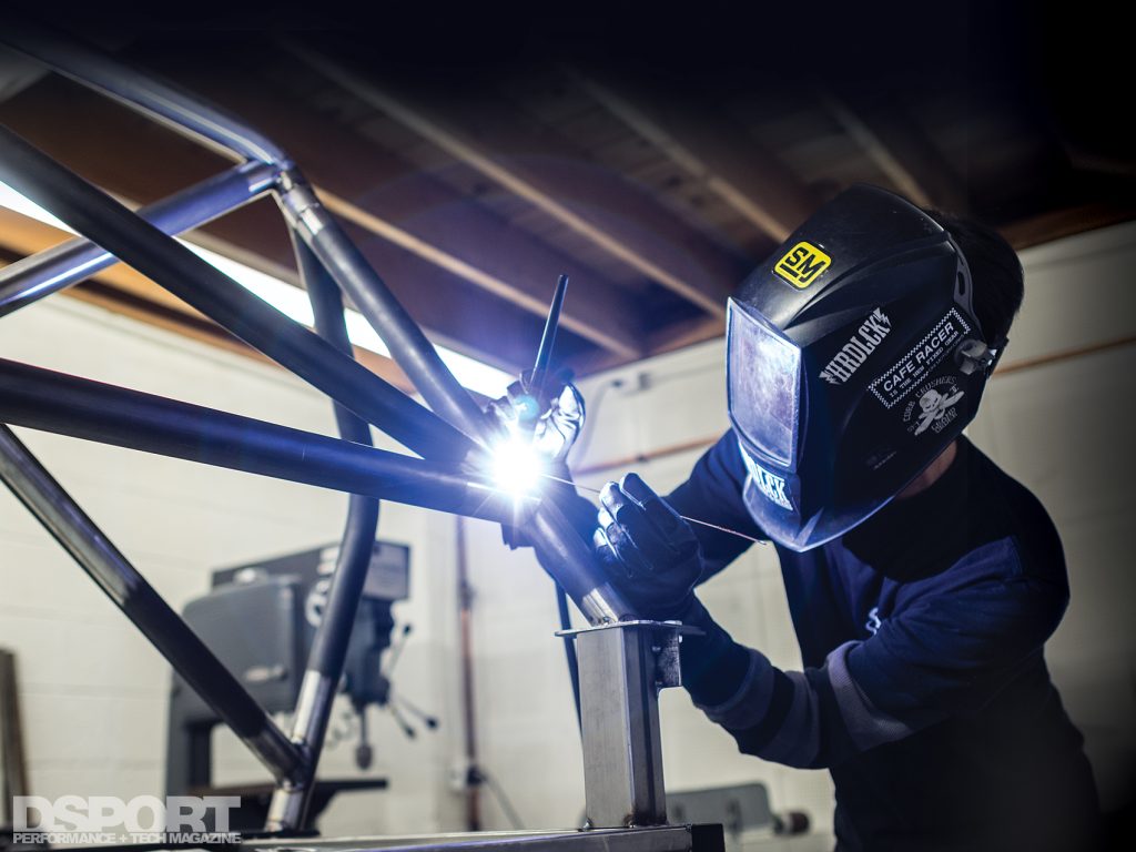 Len Higa welding a cage